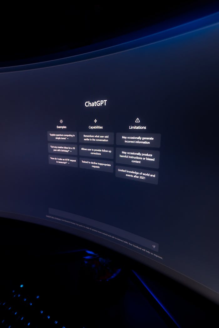 Close-up of ChatGPT's interface displayed on a curved monitor in a dimly lit environment.