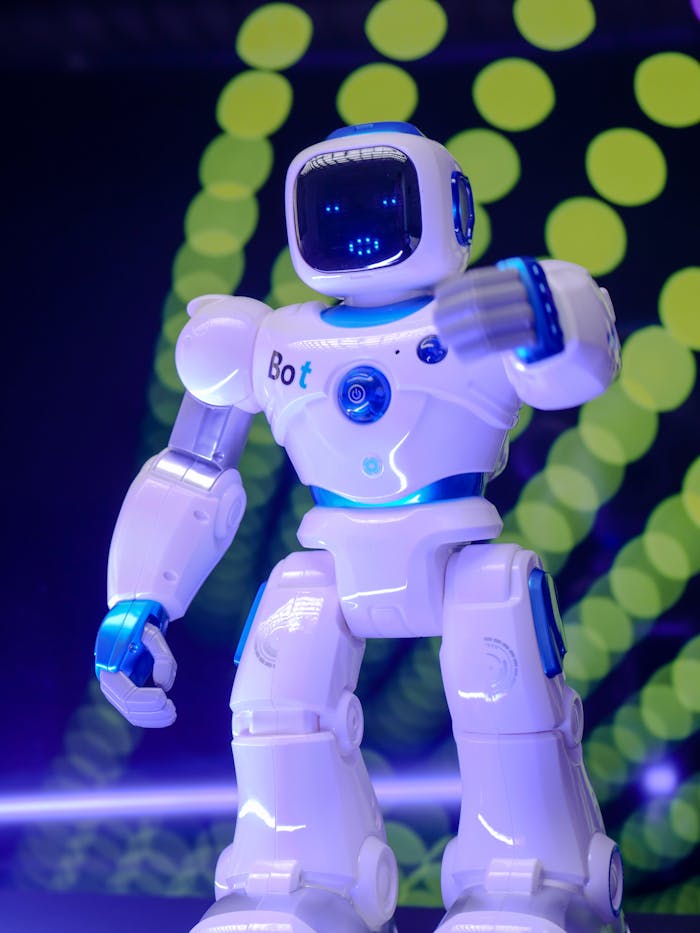 pexels photo 8566531 White humanoid robot showcasing modern technology with glowing backdrop.
